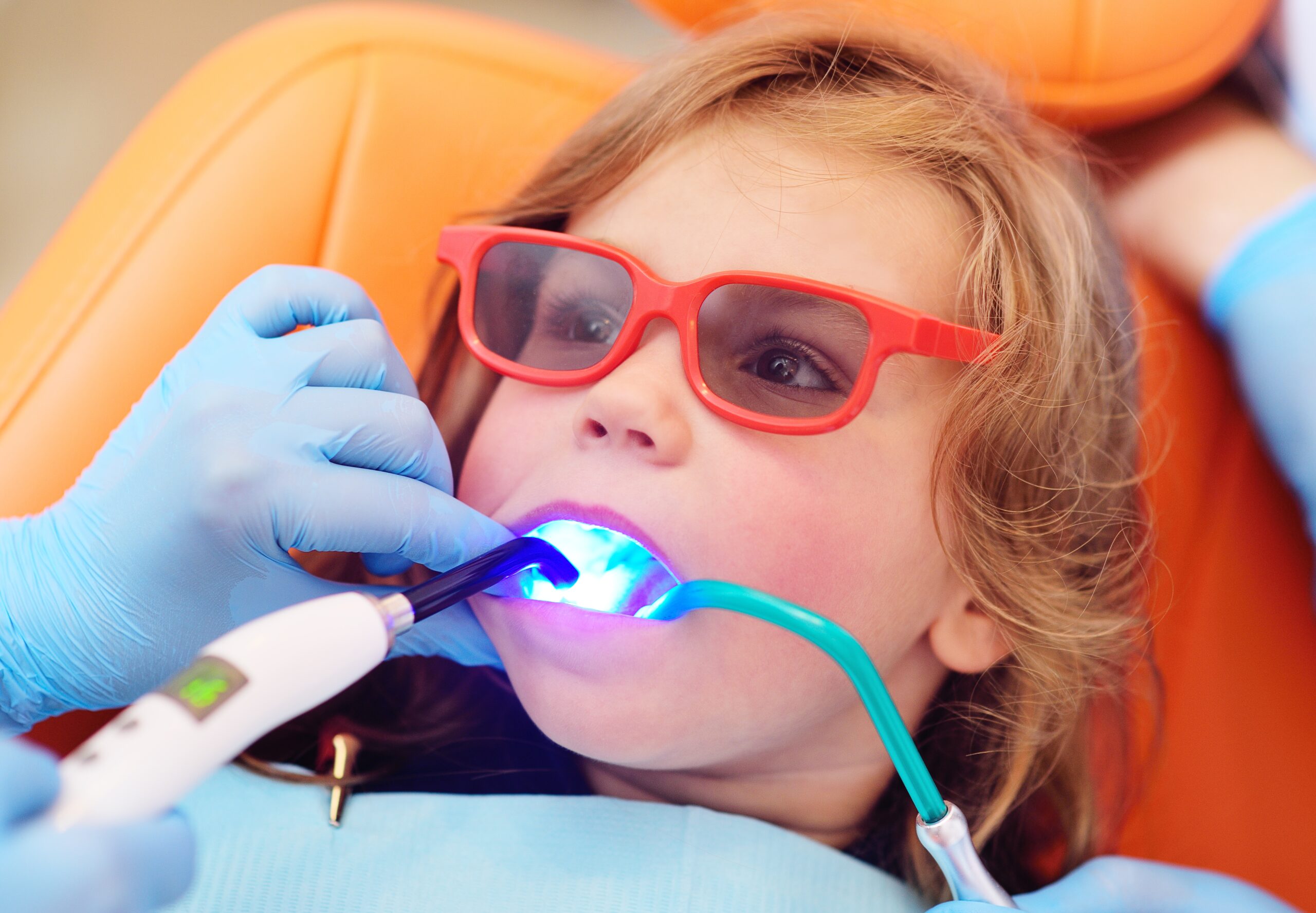 Pediatric,Dentist,Seals,The,Teeth,Of,A,Little,Girl,In